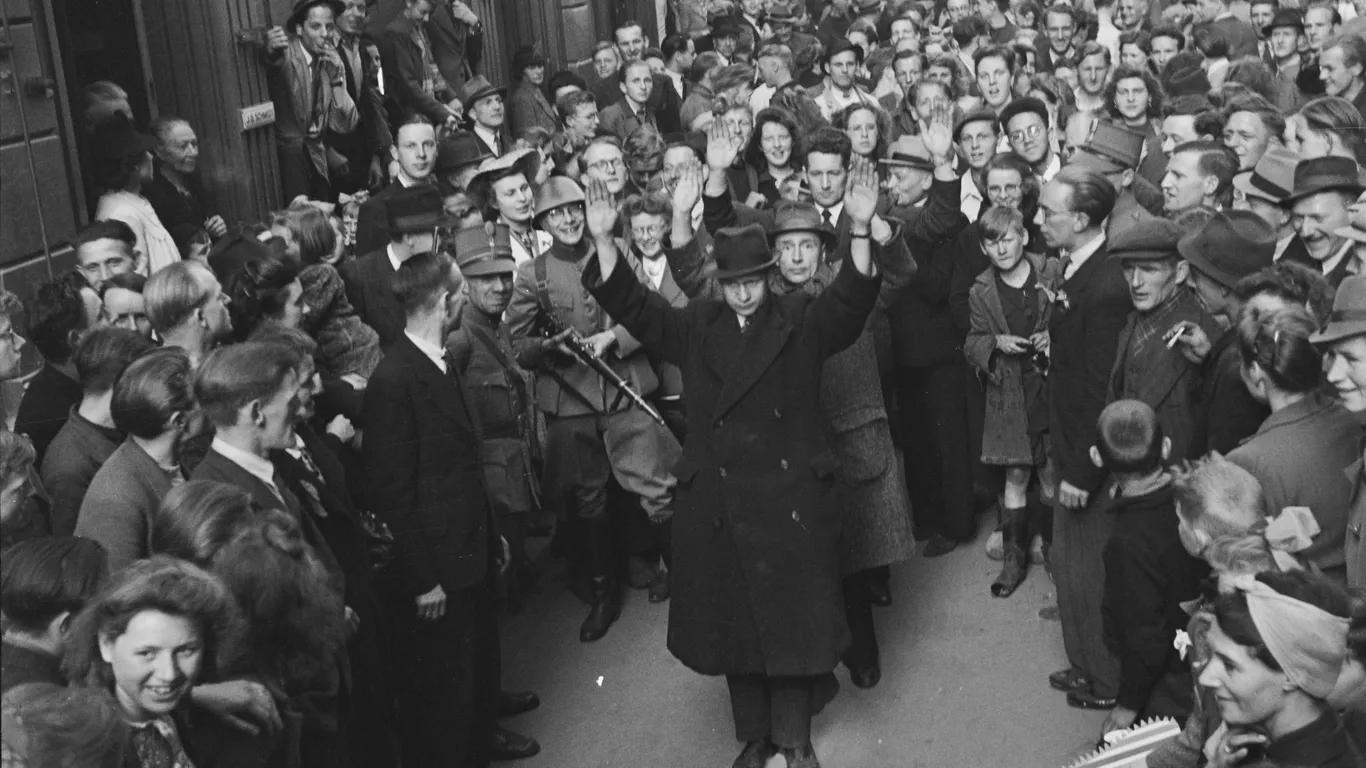 Studenten spelen op de Nijmeegse Grote Markt een ‘bevrijdingsspel’ vlak na het einde van de oorlog. Ze steken de draak met onder andere NSB-voorman Mussert.