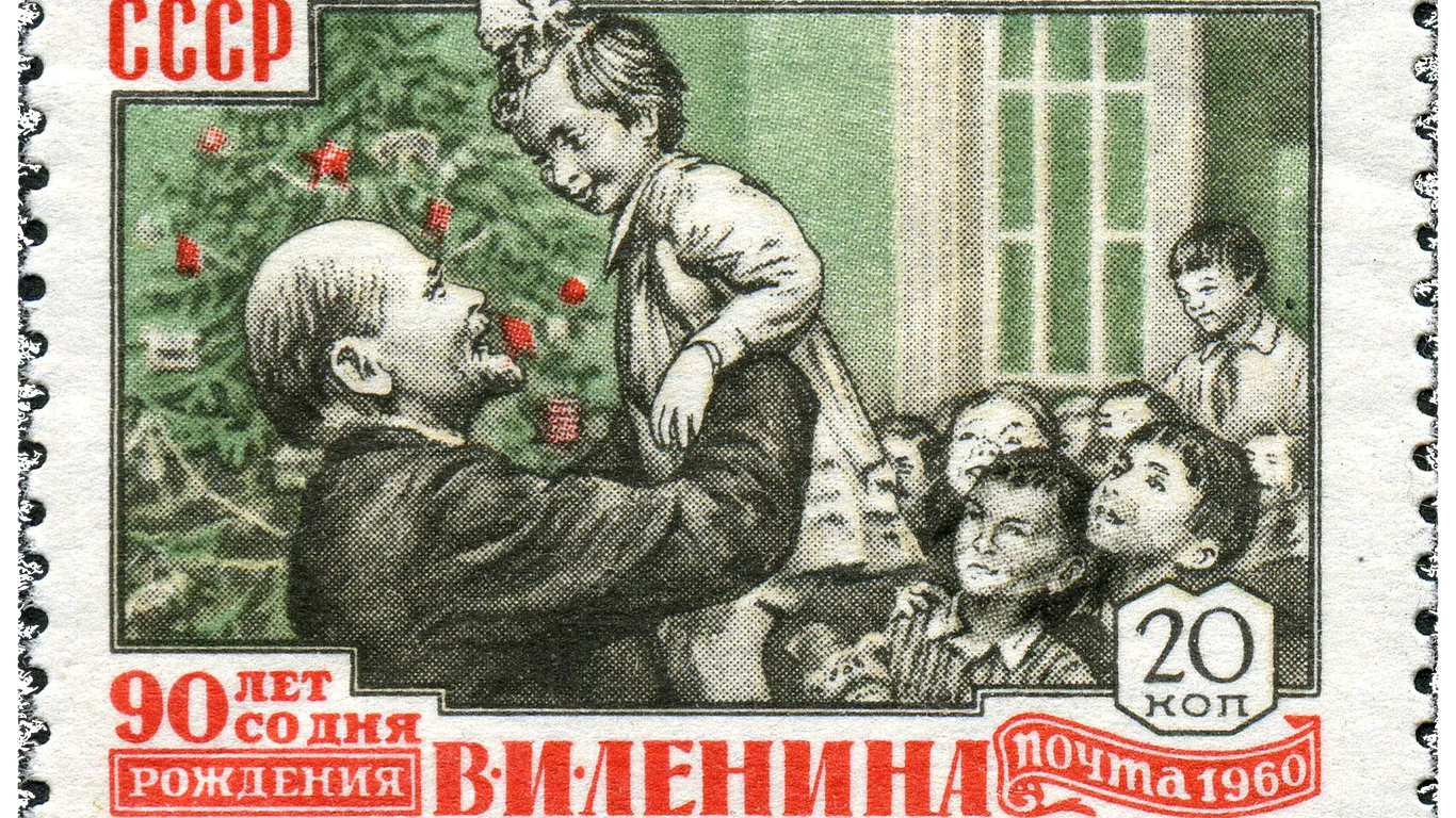 Feestdagenpostzegel uit de Sovjet-Unie met Lenin die een kind optilt, gepubliceerd in 1960.